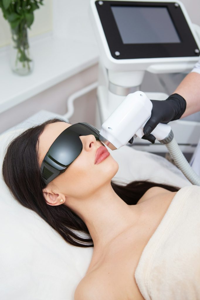 The process of laser hair removal of the female body. Professional cosmetology